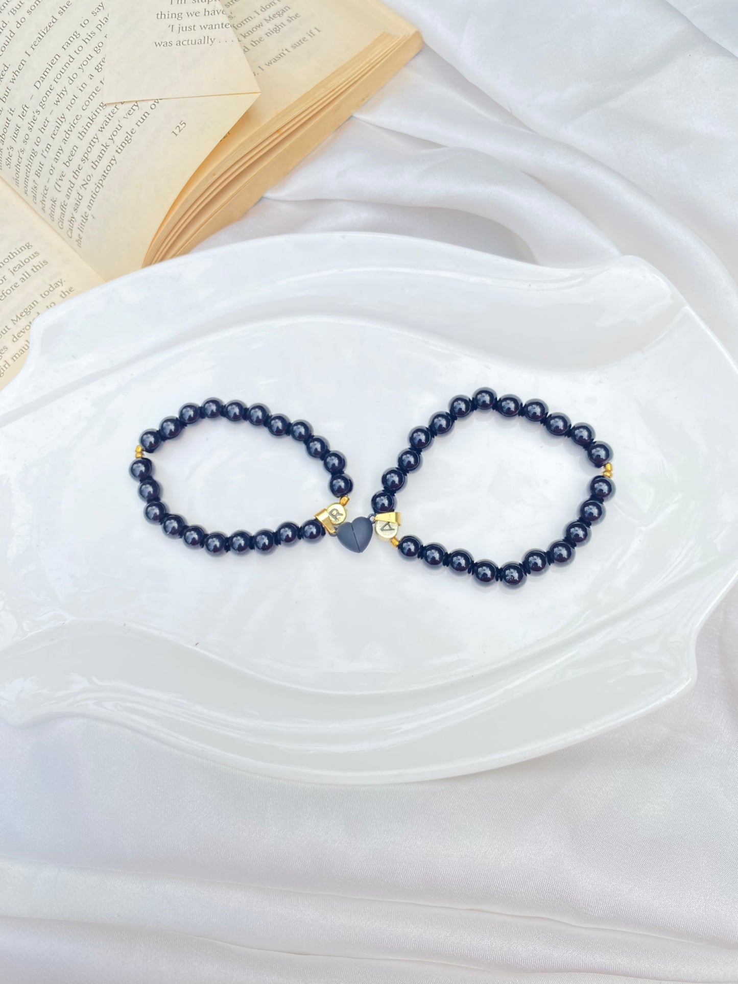 Magical black heart bracelet pair .