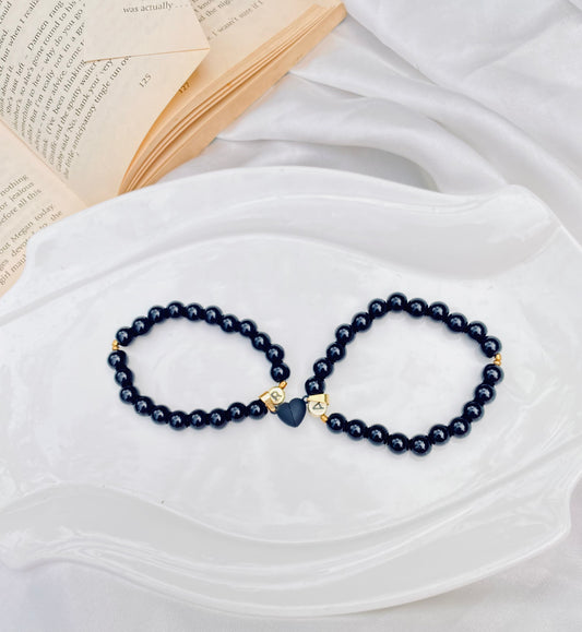 Magical black heart bracelet pair .